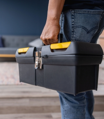 Electrician carrying an electrical toolbox
