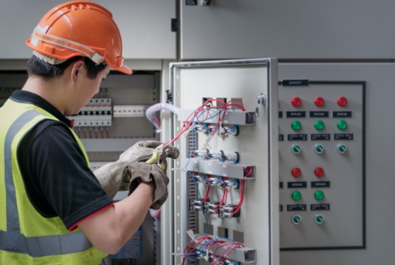 Electrician cutting wires from an electrical box
